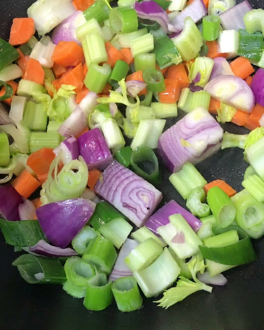 Verdure tritate saltate in una padella calda.