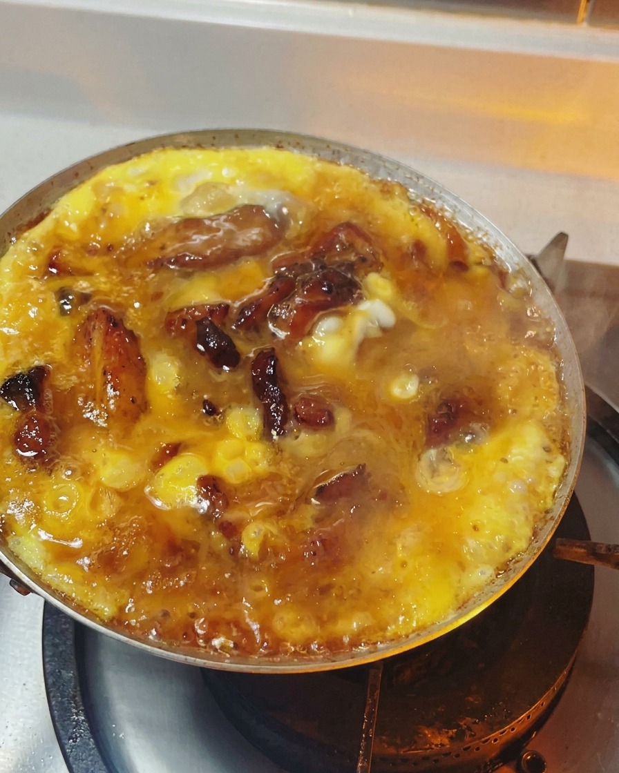 Oyakodon in padella con le uova cotte fino a una consistenza morbida, semi-solida e lucida.