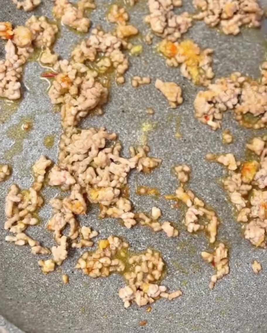 Condimenti inclusi sesamo macinato e brodo di pollo aggiunti in padella.