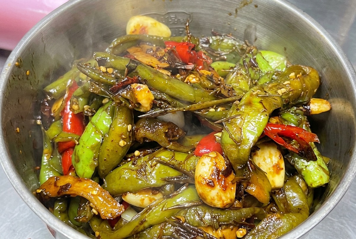 Composto di peperoni cotto trasferito nel contenitore di un frullatore.