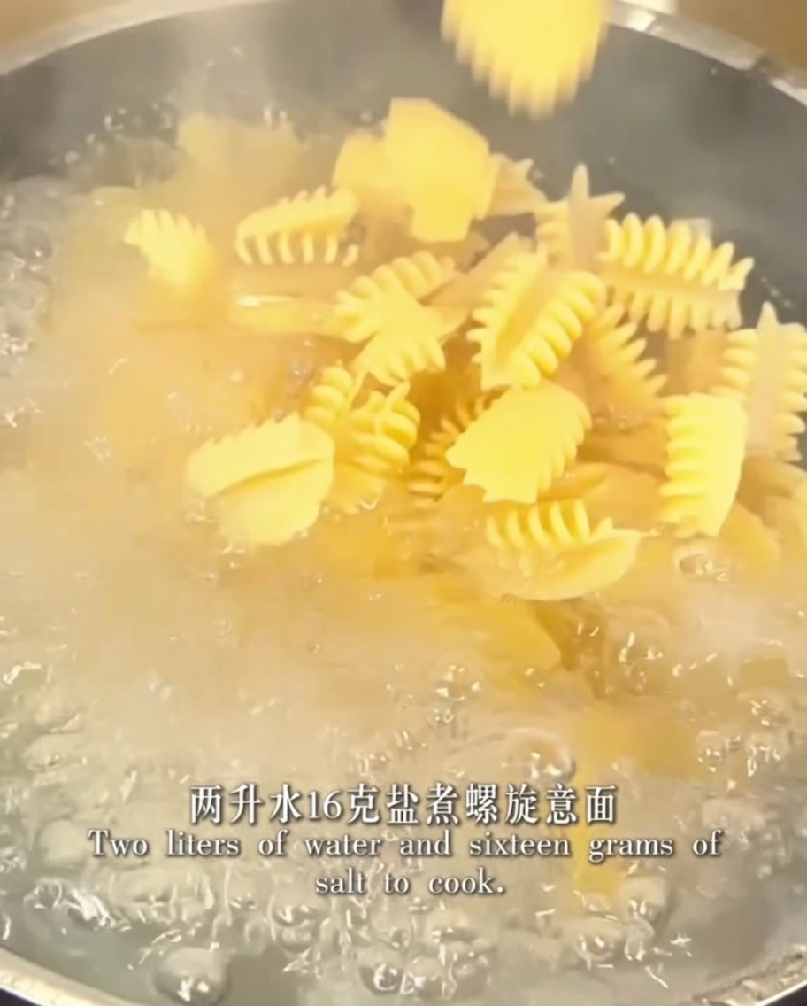 Fusilli che cuociono in una pentola di acqua bollente salata.