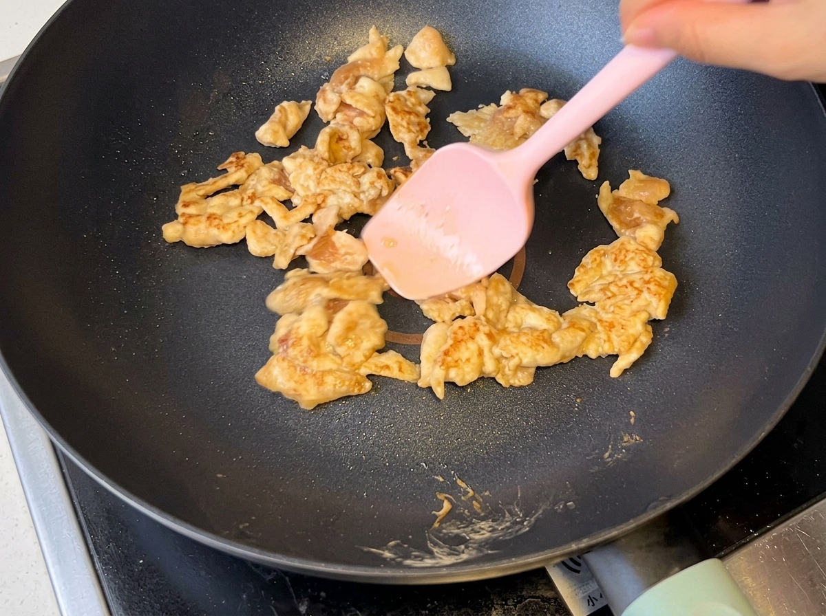 Cipolle affettate saltate insieme al pollo dorato in padella.