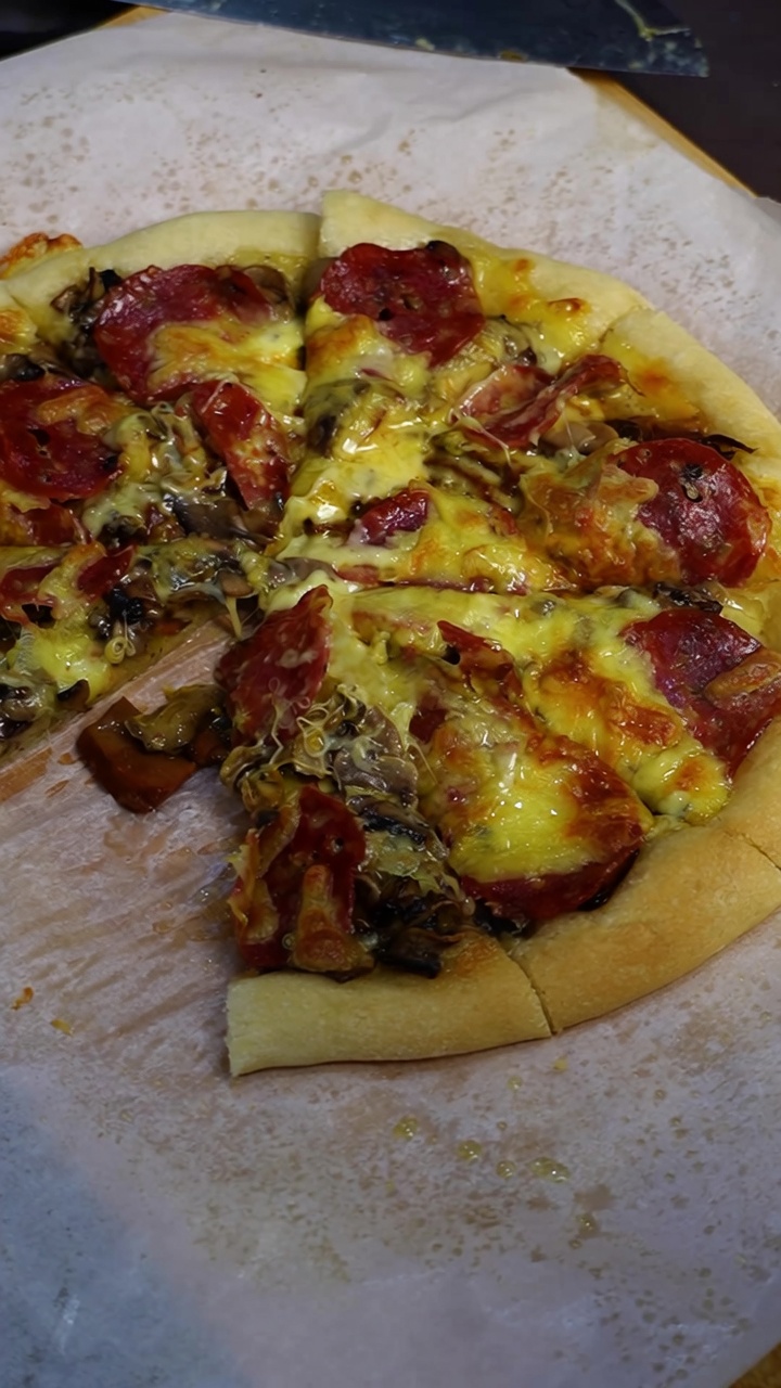 Pizza classica fatta in casa ai funghi e salame piccante