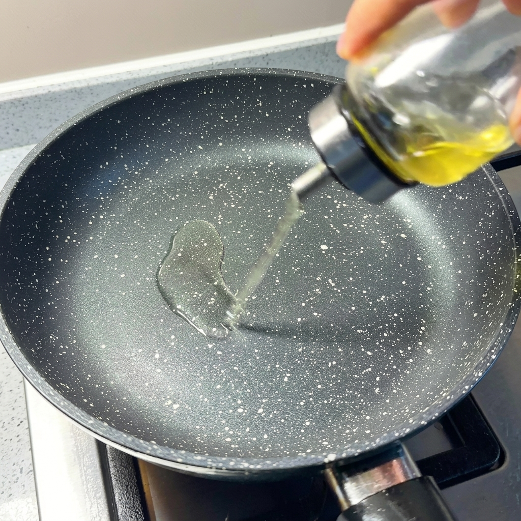 Olio versato in una padella antiaderente preriscaldata.