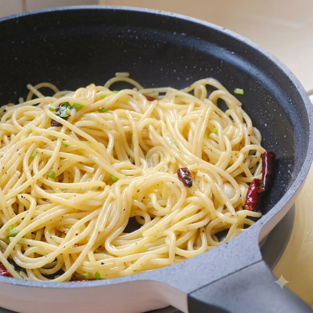 Foglie di coriandolo fresco tritate, sale marino e pepe nero cosparsi sulla pasta nella padella.