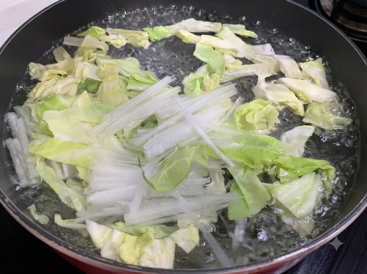 Cavolo tritato e ravanello bianco che bollono in una padella dacqua.