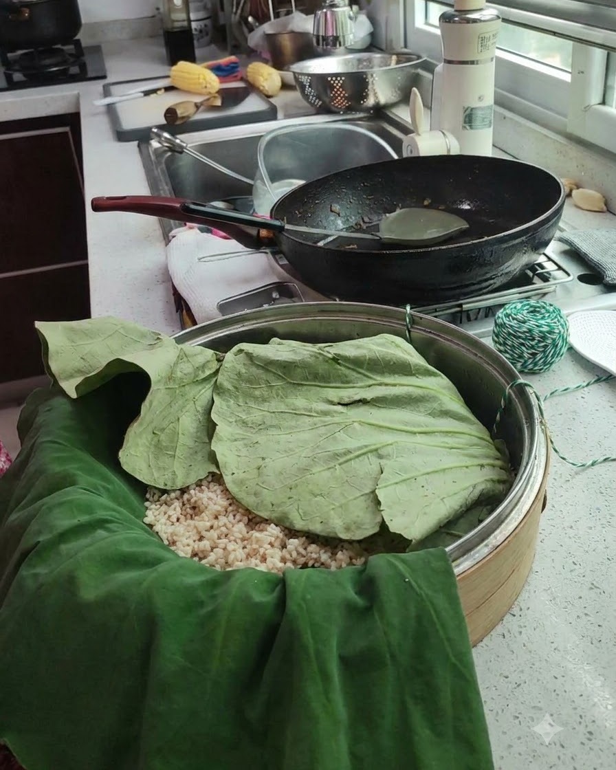 Un pacchetto di foglie di loto avvolto inserito in un cestello per la cottura al vapore con spago da cucina verde e bianco vicino.