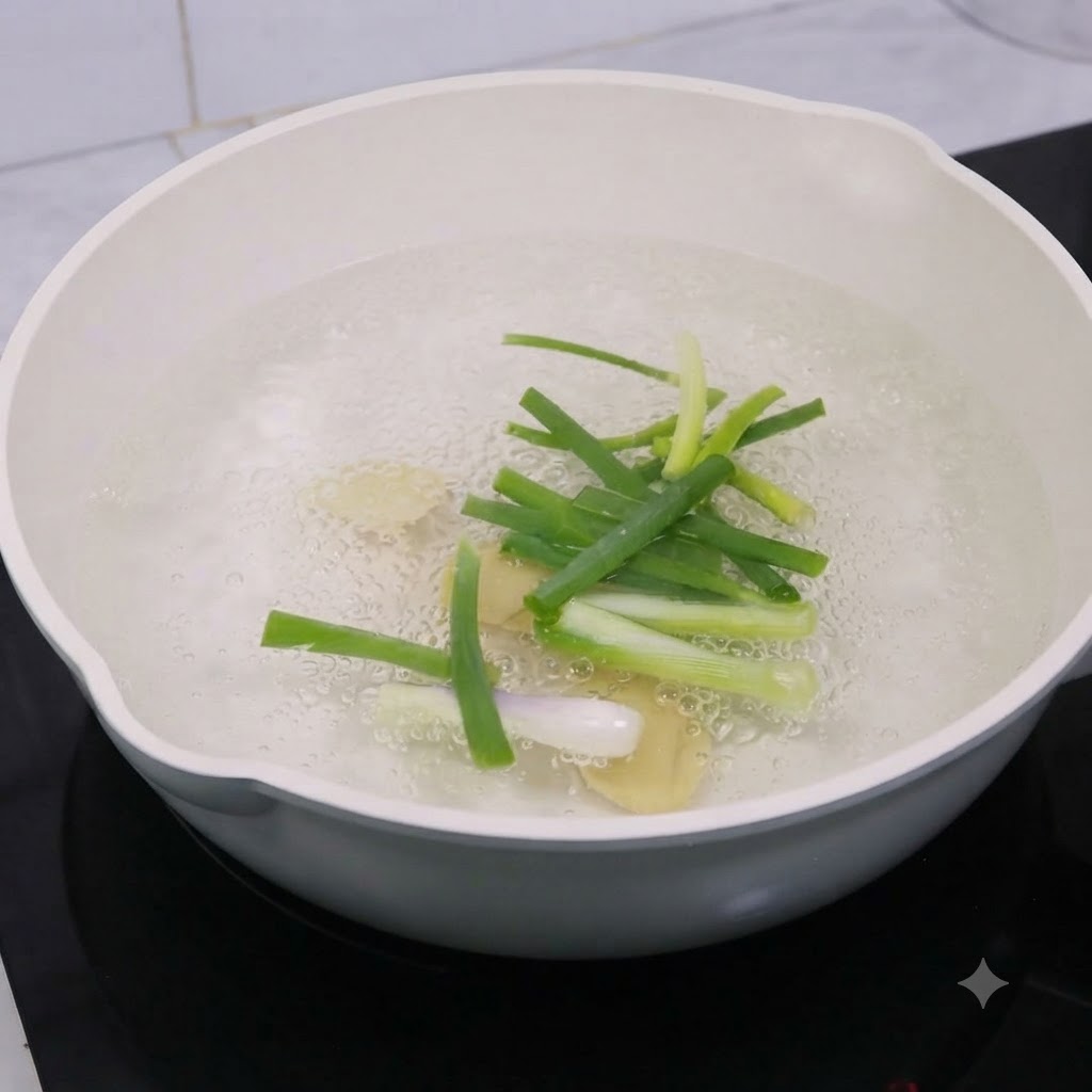 Fette di zenzero e cipollotti in ebollizione in una pentola dacqua con vino da cucina.