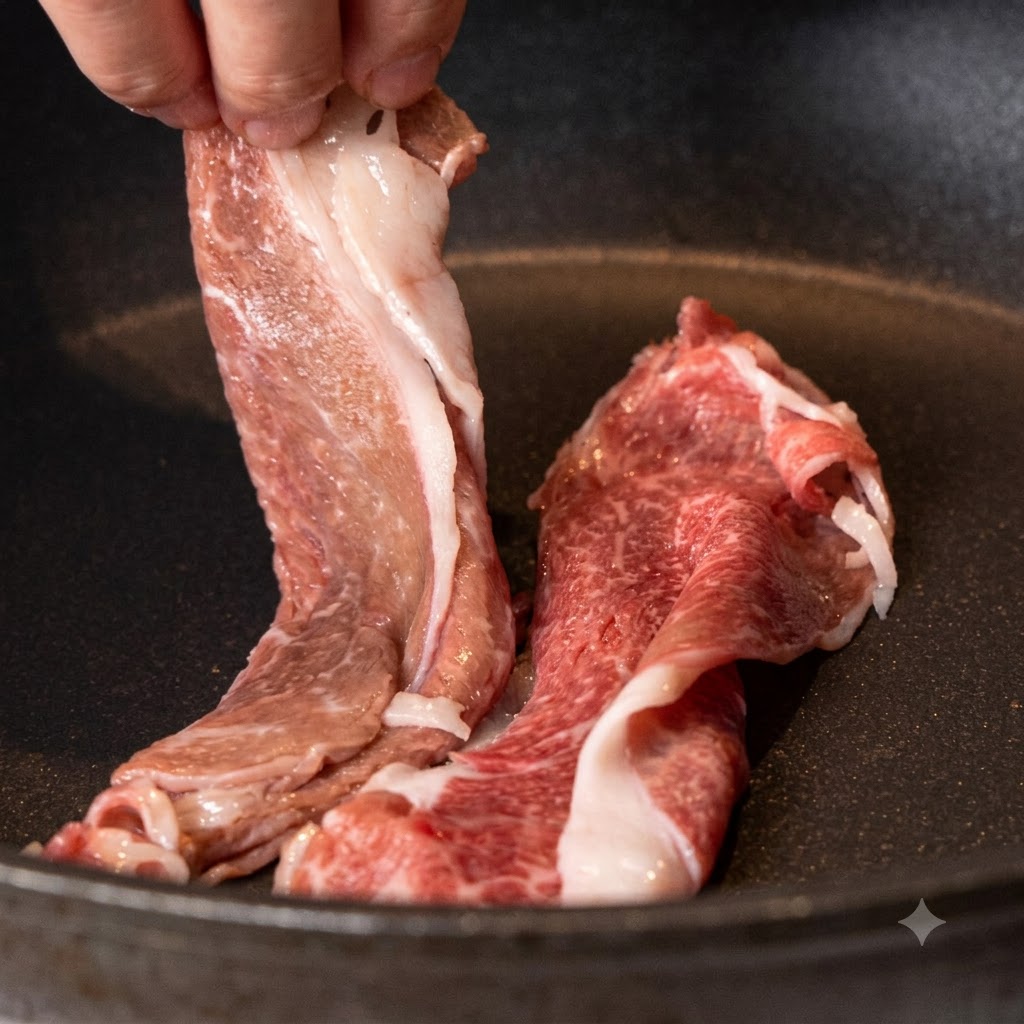 Fette di manzo wagyu messe in una padella antiaderente asciutta e riscaldata.