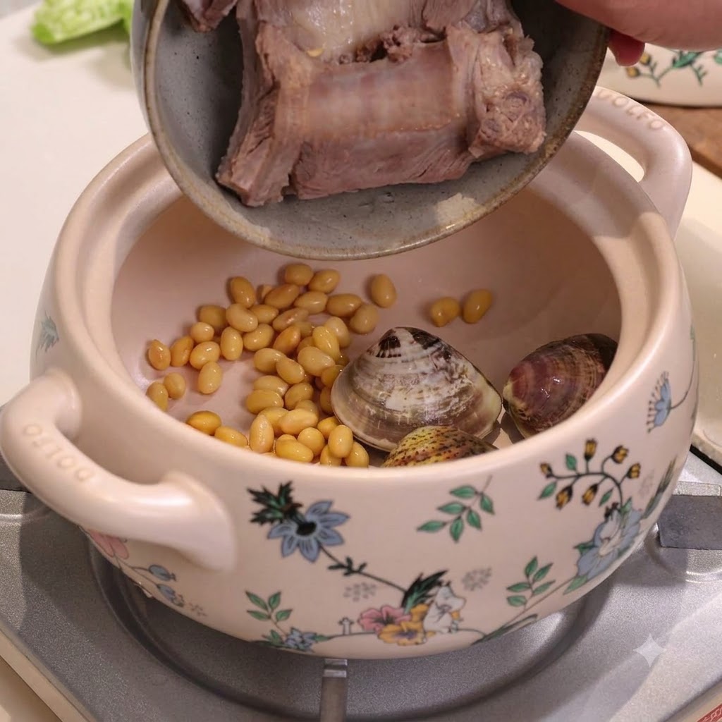 Costine di maiale sbollentate versate in una pentola di ceramica contenente soia e vongole.